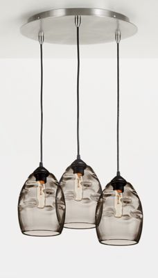 three glass pendant lights hanging from a ceiling