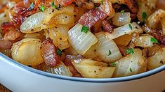 a white bowl filled with cooked onions and bacon