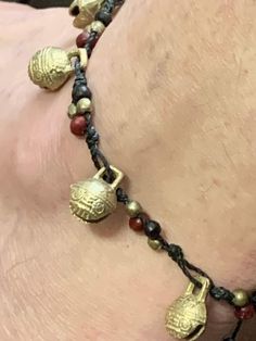 Anklet Bhutan Tibetan Brass Temple Bells. Tiny wood red and black and brass beads. Hand knotted on Black cord that adjusts to fit any size ankle. Bells have a pleasant and light jingle. Beautiful pattern and design. Waterproof. Available in a red or purple combination of colors. Choose at checkout. Adjustable Festival Jewelry With Bells, Adjustable Bells Jewelry For Festivals, Adjustable Red Brass Jewelry, Ankle Bells, Purple Combination, Temple Bells, Jewellery Bracelets, Brass Beads, Small Gift Bags