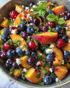 a bowl filled with fruit and feta cheese