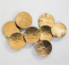 gold and silver discs on a white background