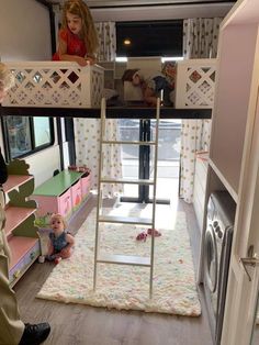 a woman standing next to a child on top of a bunk bed in a room