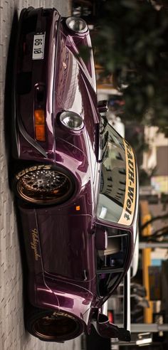 a purple car parked on the side of a building