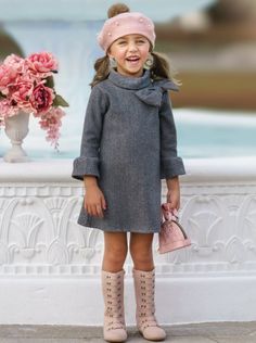 This adorable A-line dress is so Fall-ishously simple and stylish. So chic with darling ruffle cuffs and bow detailing. She'll spend hours twirling with joy. Sensible for dressy and semi-formal occasions A quality fabric that's soft on the skin and withstands wash after wash Perfect for fall, school, winter, birthday parties, and special events Long-sleeve A-line dress with a wide turtle neck, large bow detail, and ruffled scuffs Includes dress in sizes 2T-10Y Fall Dressy, Paris Christmas, Fall Birthday Parties, Toddler Flower Girls, Christmas Pics, Girls Dress Outfits, Toddler Flower Girl Dresses, Infant Flower Girl Dress