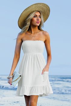 The White Smocked Bodice Tube Top Cover-Up Dress is a stylish and comfortable option for layering over your swimsuit. Product code: CAA07B4C056CC Features:  Knit Straight neckline Sleeveless Smocked bodice  Patch pocket Ruffle hem Mini Wash Method: Regular Wash Material: 100%POLYESTER. Bandeau Beach Dress With Ruffles, Bandeau Sundress For Summer Vacation, Strapless Summer Mini Dress For Beach, Strapless Mini Dress For Beach Vacation, Solid Color Beachwear Dresses For Day Out, Spring Bandeau Sundress For The Beach, Spring Bandeau Sundress For Beach, Bandeau Sundress For Summer Beach, Summer Bandeau Sundress For The Beach