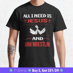 a man wearing a t - shirt that says all i need is jesus and arm wrestling