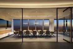 a conference room with large glass walls overlooking the city