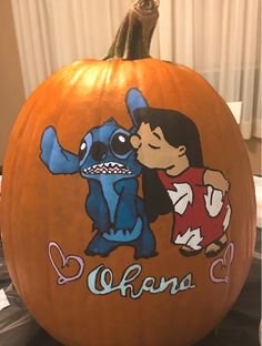 a pumpkin decorated with an image of stitch and stitch kissing on the face of a cartoon character