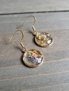 Rainbow mixed flowers dangling earrings with resin petite gold pendants of dried multicolored flowers. ♡ These earrings are handmade from the very first step. I personally collect and dry the natural elements, and create each beautifully preserved shape with resin formulas.  Be sure to check out the RED EARRINGS section at EarringsbyLCreations for all beautiful red colored earrings available! https://www.etsy.com/shop/EarringsByLCreations?section_id=28420977 Made with quality materials and alway Gold Botanical Dangle Earrings, Gold Pressed Flower Earrings, Gold Pressed Flowers Dangle Earrings, Gold Botanical Earrings With Pressed Flowers, Botanical Gold Earrings With Pressed Flowers, Gold Dangle Earrings With Pressed Flowers, Gold Flower Earrings With Birth Flower Detail, Rose Gold Flower-shaped Earrings With Pressed Flowers, Gold Dangle Earrings With Birth Flower