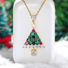 Enjoy the magic of Christmas with this spirited tree pendant. Bright and colorful, this Christmas tree pendant is sure to showcase your sense of holiday cheer. A combination of green, blue, red and white stones, the necklace will show a very sparkling look on your neck. A festive look that will go with any outfit, this sterling silver christmas tree necklace will be a lovely gift for her this December!Carat Weight: 3.615 ctStone Size: 4*4,2.8,3.5,2.8,2.8,2.8 mmStone Type: Jeulia® StoneNumber of Multicolor Christmas Jewelry Gift, Multicolor Jewelry Christmas Gift, Green Festive Jewelry For New Year, Green Jewelry For New Year's Gift, Green Jewelry For New Year Gift, Green Jewelry As A New Year Gift, Green Necklace Christmas Gift, Christmas Jewelry Gift For Her, Christmas Holiday Pendant Necklaces