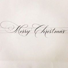 the word merry christmas written in cursive writing on a white sheet of paper