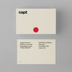 two white business cards with red dots on them