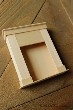 an empty wooden box sitting on the floor