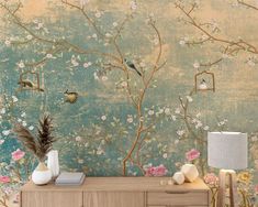 the wallpaper in this room is painted with flowers, birds and branches on it