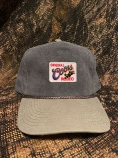 Coors Rodeo patch on a Gray vintage rope brim snapback hat. Vintage Flat Brim Dad Hat For Outdoor, Vintage Adjustable Dad Hat For Outdoor, Vintage Adjustable Snapback Hat With Curved Brim, Vintage 5-panel Outdoor Hat, Vintage 5-panel Dad Hat For Outdoor, Vintage Snapback Fitted Hat For Outdoor, Vintage 5-panel Dad Hat, Vintage Adjustable 5-panel Snapback Hat, Vintage Snapback Hat With Curved Brim And Logo Patch