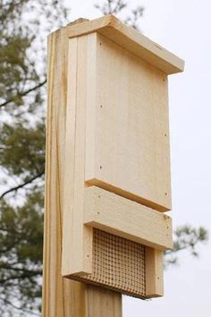 a bird house built on top of a wooden post