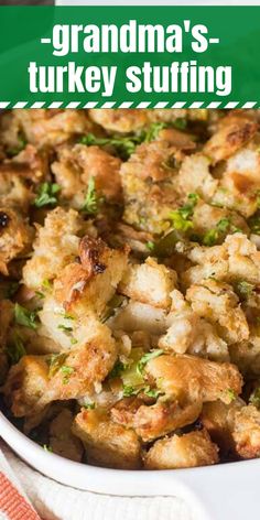 a white dish filled with stuffing on top of a table