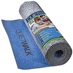 a roll of blue carpet next to a roll of gray fabric on top of it