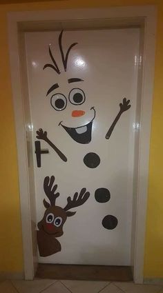 a door decorated to look like a snowman with reindeer noses and nose paint on it