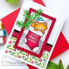 a close up of a card with a cat in a christmas stocking on it