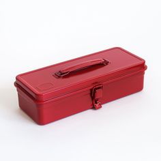 a red lunch box sitting on top of a white table