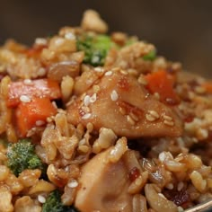 a bowl filled with rice, broccoli and carrots on top of it