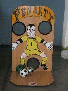 a wooden toy with a soccer player painted on it's face and two balls in front of it