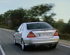 a silver mercedes cls driving down the road