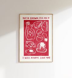 a red poster hanging on the wall in a room with white walls and flooring