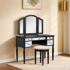 a black and white vanity with mirror and stool