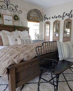 a bedroom with white brick walls and black iron bed frame, wooden sleigh headboard