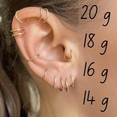 a woman wearing three different ear piercings on her left ear with the measurements below it