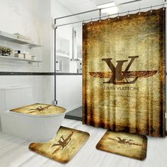 a bathroom with a shower curtain, toilet and rugs that have the louis vuitton logo on it