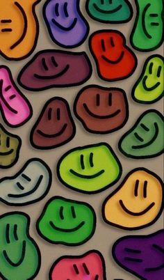 many different colored smiley faces on a white surface