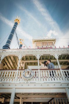 a couple kissing on the balcony of a building