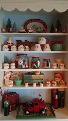 a shelf filled with lots of christmas decorations and other holiday items on top of it