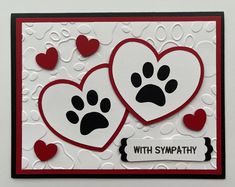 a card with two hearts and paw prints on it