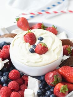 a white plate topped with berries and whipped cream