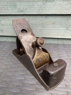 an old metal object sitting on top of a brick floor