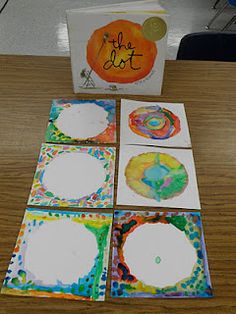 four cards with different designs on them sitting on a table