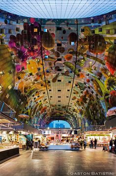 the ceiling is decorated with many colorful balloons and other things on display at the store