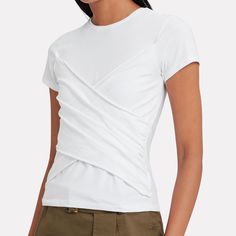 The Label Reworks The Wardrobe Staple T-Shirt With A Twist. Baby Tee Cropped Silhouette. Wrap Twist Detail In Front. Crew Neckline. Pull-Over Style. In White. Fabric: 94% Pima Cotton, 6% Spandex Machine Wash Summer Layering Tops With Foldover Shape, White Fitted Knit Top For Layering, Fitted Short Sleeve Blouse For Layering, Fitted Short Sleeve Tops For Layering, White Short Sleeve Top For Layering, Fitted Knit Top With Short Sleeves For Layering, White Fitted Blouse With Crew Neck, Fitted Short Sleeve Knit Top For Layering, Cotton Short Sleeve Knit Top For Layering