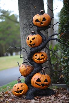 pumpkins are arranged on the branches of a tree