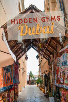 an alley way with the words hidden gems in arabic