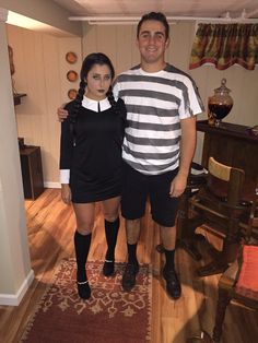 the man and woman are dressed up in costumes for halloween time, posing for a photo