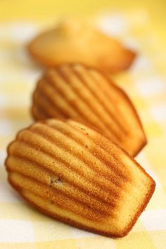 three pieces of bread sitting on top of a yellow and white checkered table cloth