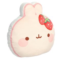 a white stuffed animal with a strawberry on it's head and ears, sitting in front of a white background