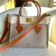 Louis Vuitton On My Side Tote Mm, Galet. I Have Included A Screenshot Of My Purchase Records From My Lv App. The Bag Has Been Used Maybe 4 Times & Is In Perfect Condition, No Stains, Tears, Scratches, Etc! I Take Very Good Care Of My Bags, You Will Be Very Impressed! Luxury Taupe Bag With Top Carry Handle, Luxury Taupe Rectangular Satchel, Luxury Taupe Crossbody Satchel, Luxury Beige Satchel With Branded Hardware, Luxury Taupe Satchel With Removable Pouch, Designer Taupe Bags With Gold-tone Hardware, Designer Taupe Evening Bags, Louis Vuitton On My Side, My Bags