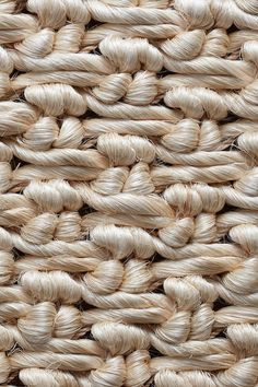 close up view of the texture of a woven rug with white yarn on top and bottom