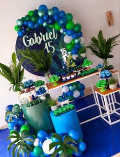 a table with balloons and plants on it